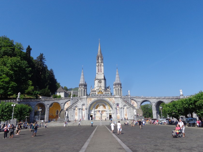 La Basilique de Lourdes, et ci-dessous, les nombreux pèlerins, certains handicapés, venus prier devant la grotte de Massabielle, mercredi 15 juillet.